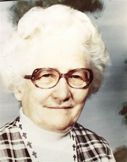 older woman with white hair and glasses