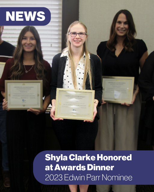 woman posing for the camera holding a framed certificate