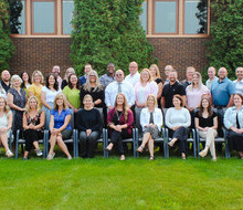 large group of men and women posing for the camera