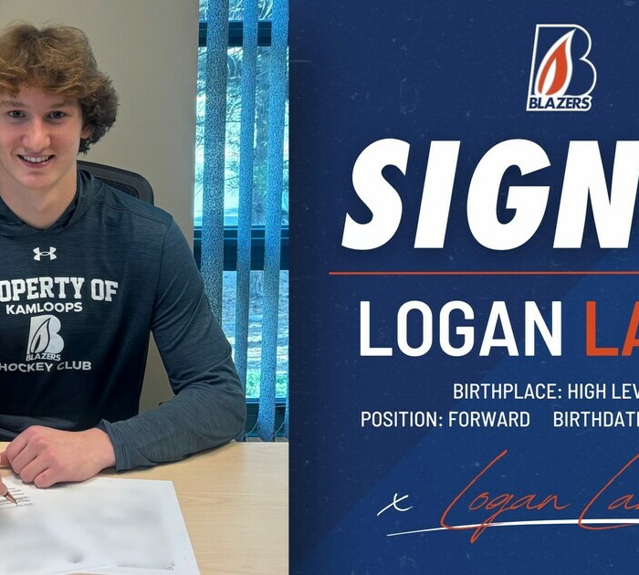 teen boy signing papers and posing for the camera