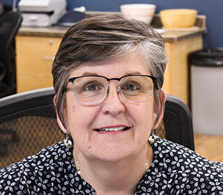 woman with short dark hair smiling for the camera