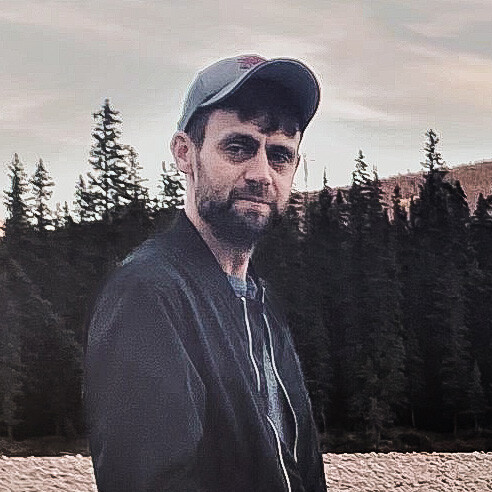 man wearing ballcap looking at the camera