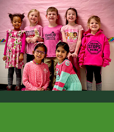 Kids wearing pink posing together