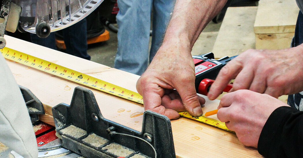 assortment of hand tools on wooden surface