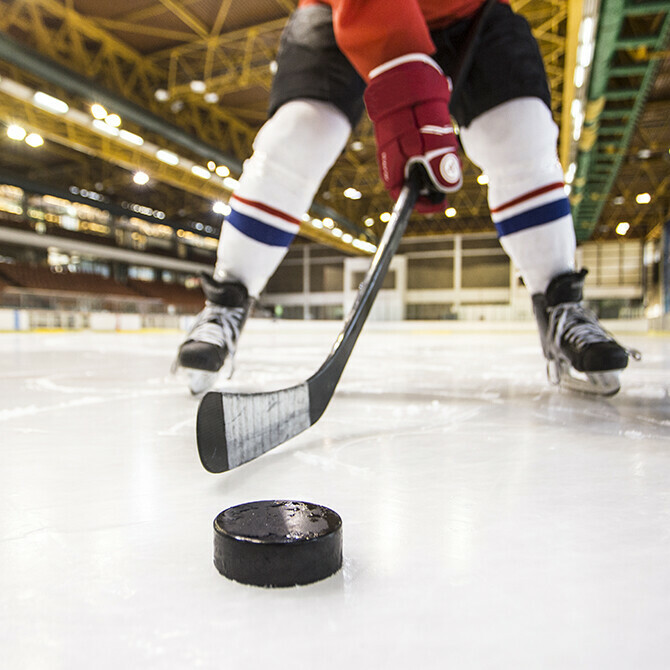 hockey player on the ice with stick and puck
